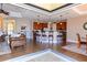 Open-concept living area with kitchen, bar seating, and access to outdoor space at 3606 Whippoorwill Blvd, Punta Gorda, FL 33950
