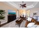 Spacious living room with a decorative ceiling fan, fireplace, and comfortable seating with views to the foyer at 3606 Whippoorwill Blvd, Punta Gorda, FL 33950