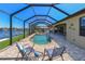 Screened-in pool area featuring comfortable seating and a canal view, perfect for relaxation and waterfront living at 3606 Whippoorwill Blvd, Punta Gorda, FL 33950