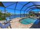 A screened-in pool with a picturesque canal view, inviting relaxation and outdoor enjoyment by the waterfront at 3606 Whippoorwill Blvd, Punta Gorda, FL 33950