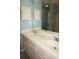 Vanity with double sinks and a large mirror, adjacent to the tiled shower at 594 W Tarpon Nw Blvd, Port Charlotte, FL 33952