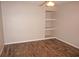 Bright bedroom featuring hardwood flooring, ceiling fan, and custom built-in shelving at 594 W Tarpon Nw Blvd, Port Charlotte, FL 33952