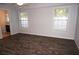 Spacious bedroom with wood-look floors and natural light from two windows at 594 W Tarpon Nw Blvd, Port Charlotte, FL 33952