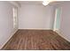 Bedroom features wood-look floors, natural light, and ensuite access at 594 W Tarpon Nw Blvd, Port Charlotte, FL 33952