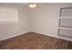 Bedroom with hardwood flooring, ceiling fan, and built-in shelving at 594 W Tarpon Nw Blvd, Port Charlotte, FL 33952