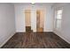 Open bedroom with wood-look floors, closet and bathroom access at 594 W Tarpon Nw Blvd, Port Charlotte, FL 33952
