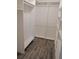 Walk-in closet featuring built-in shelving and wood-look flooring at 594 W Tarpon Nw Blvd, Port Charlotte, FL 33952