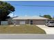 Charming single-story home with well-maintained lawn and a lighthouse decoration at 594 W Tarpon Nw Blvd, Port Charlotte, FL 33952