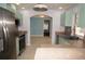 Well-lit kitchen showing stainless steel appliances, counter space, and view to living area at 594 W Tarpon Nw Blvd, Port Charlotte, FL 33952