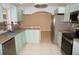 Well-lit kitchen featuring stainless steel appliances and stylish light green cabinets and drawers at 594 W Tarpon Nw Blvd, Port Charlotte, FL 33952