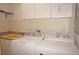 Bright laundry room featuring washer and dryer and cabinet storage at 594 W Tarpon Nw Blvd, Port Charlotte, FL 33952