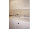 Bright laundry room featuring a newer washer and dryer and storage above at 594 W Tarpon Nw Blvd, Port Charlotte, FL 33952