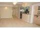 Bright living room featuring tile flooring and a breakfast bar adjacent to the kitchen at 594 W Tarpon Nw Blvd, Port Charlotte, FL 33952