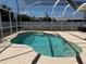 Screened pool with large white fence in a spacious backyard at 594 W Tarpon Nw Blvd, Port Charlotte, FL 33952