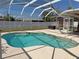 Inviting screened-in pool offers a refreshing escape and outdoor entertainment space at 594 W Tarpon Nw Blvd, Port Charlotte, FL 33952