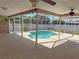 Large screened-in pool with spacious patio and white privacy fence at 594 W Tarpon Nw Blvd, Port Charlotte, FL 33952