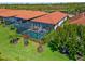 Aerial of home featuring a private, screened-in pool and landscaped backyard at 10357 Crooked Creek Dr, Venice, FL 34293