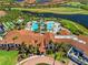Aerial view of the community pool area, featuring a large pool, cabanas, and surrounding landscaping at 10357 Crooked Creek Dr, Venice, FL 34293