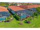 Aerial view of a home featuring a screened-in pool, chairs and manicured backyard at 10357 Crooked Creek Dr, Venice, FL 34293
