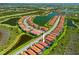 Aerial view of a vibrant community surrounded by serene lakes and lush green spaces at 10357 Crooked Creek Dr, Venice, FL 34293