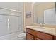 Well-lit bathroom featuring a vanity with a sink, a toilet, and a shower/tub combination with a glass door at 10357 Crooked Creek Dr, Venice, FL 34293