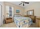Cozy bedroom with neutral color palette, highlighting a bed with blue accents and dresser with mirror at 10357 Crooked Creek Dr, Venice, FL 34293
