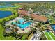 Aerial shot of a resort-style pool, clubhouse, and golf course within a luxurious community at 10357 Crooked Creek Dr, Venice, FL 34293