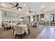 Elegant dining room featuring tables with white tablecloths, patterned chairs and views of the outdoors at 10357 Crooked Creek Dr, Venice, FL 34293