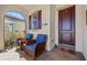 Cozy front porch with comfortable seating, a decorative shark, and welcoming decor at 10357 Crooked Creek Dr, Venice, FL 34293