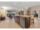 Open-concept living space featuring granite counters, stainless steel appliances, and bar seating at the kitchen island at 10357 Crooked Creek Dr, Venice, FL 34293