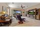 Comfortable living room featuring a ceiling fan, tile flooring, and sliding doors to an outdoor pool area at 10357 Crooked Creek Dr, Venice, FL 34293