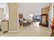 Bright, open-concept living area featuring tile floors, kitchen island, and sliding glass doors leading to the outdoor pool at 10357 Crooked Creek Dr, Venice, FL 34293