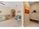 Open-concept living space with neutral tones, tile flooring, and stylish furnishings at 10357 Crooked Creek Dr, Venice, FL 34293
