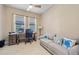 Bright home office with a comfortable couch, a desk under a window, and nautical-themed decor accents at 10357 Crooked Creek Dr, Venice, FL 34293