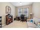 Comfortable home office featuring a gray couch, a desk by the window, and an ornate decorative shelf at 10357 Crooked Creek Dr, Venice, FL 34293