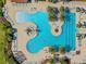 Overhead photo of resort style community pool area, featuring freeform pool, lounge chairs and palm trees at 10357 Crooked Creek Dr, Venice, FL 34293