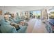 Bright living room with beach views, tile floors, and comfortable seating at 1212 Benjamin Franklin Dr # 102, Sarasota, FL 34236