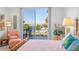 Inviting main bedroom featuring beach views, a comfortable bed, and a private balcony at 1212 Benjamin Franklin Dr # 102, Sarasota, FL 34236