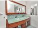 Beautiful bathroom with double vanity, mosaic backsplash, and ample storage at 122 Colonial Se St, Port Charlotte, FL 33952