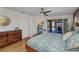 Main bedroom boasts wood floors, ceiling fan and sliding doors to the lanai and pool at 122 Colonial Se St, Port Charlotte, FL 33952
