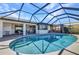 A beautiful pool with an enclosure offers a great view of the home's exterior at 122 Colonial Se St, Port Charlotte, FL 33952