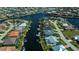 Stunning aerial shot of a waterfront property with a private dock, lush landscaping, and a screened lanai at 1230 Royal Tern Dr, Punta Gorda, FL 33950