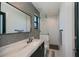 Stylish bathroom with stone accent wall, glass enclosed shower and modern fixtures at 1230 Royal Tern Dr, Punta Gorda, FL 33950