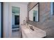 Modern bathroom with marble countertop vanity, black hardware, and view to the bedroom at 1230 Royal Tern Dr, Punta Gorda, FL 33950