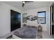 Comfortable bedroom with a ceiling fan, gray carpet, and views to the exterior at 1230 Royal Tern Dr, Punta Gorda, FL 33950