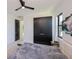 Bright bedroom featuring sleek black closet doors, modern ceiling fan, and plenty of natural light at 1230 Royal Tern Dr, Punta Gorda, FL 33950