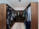 Spacious walk-in closet with custom wood shelving and drawers for optimal storage and organization at 1230 Royal Tern Dr, Punta Gorda, FL 33950