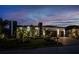 Contemporary home showcasing professional landscaping, a two-car garage, and modern architectural elements at twilight at 1230 Royal Tern Dr, Punta Gorda, FL 33950