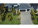 Aerial view of landscaped front yard with a dark gray roof and a two-car garage at 1230 Royal Tern Dr, Punta Gorda, FL 33950