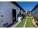 Home exterior featuring landscaped side yard and a modern white and black design at 1230 Royal Tern Dr, Punta Gorda, FL 33950